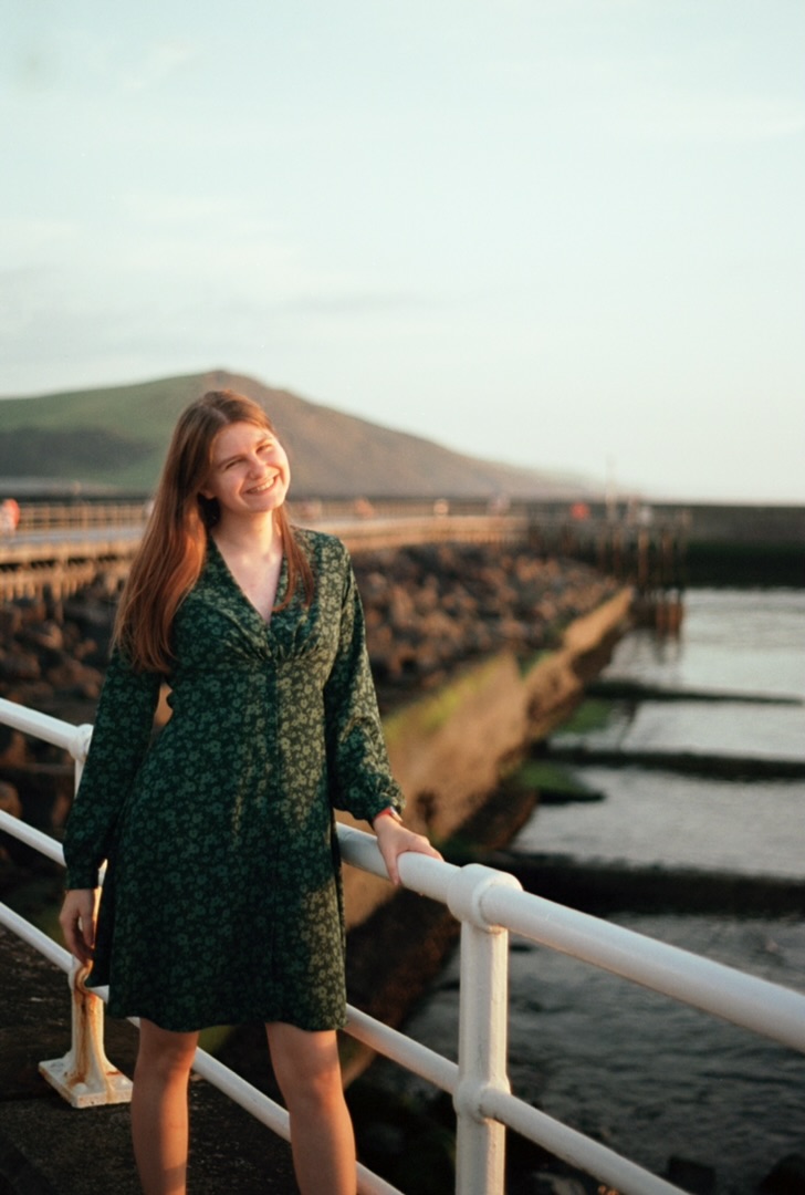 Lena standing on a beach in Wales